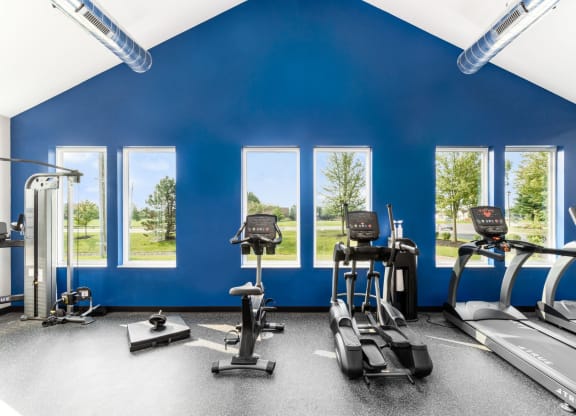 A gym with treadmills, exercise bikes, and elliptical machines at Estates at Brentwood Lake Apartments, Reynoldsburg, OH