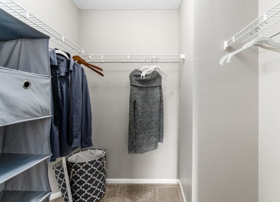 A small closet with a coat hanging on the rack. at Estates at Brentwood Lake Apartments, Reynoldsburg, OH, 43068