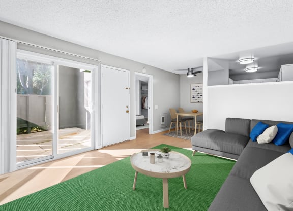 a living room with a green rug and a couch