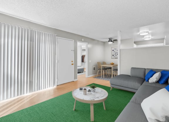 a living room with a green rug and a couch