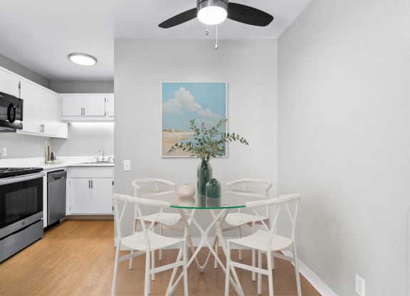 an open kitchen and dining room with a table and chairs