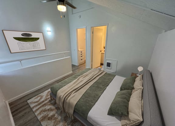 a bedroom with a bed and a door to a bathroom