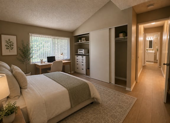 A bedroom with a bed, desk, and chair.