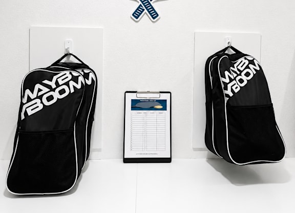Pickleball equipment displayed on a wall with a sign above it.