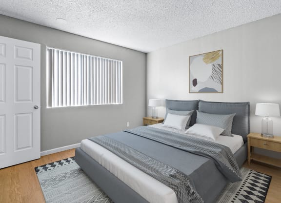 a bedroom with a large bed and a window