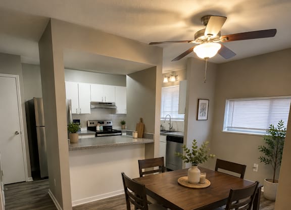 A dining room with a table set for four.