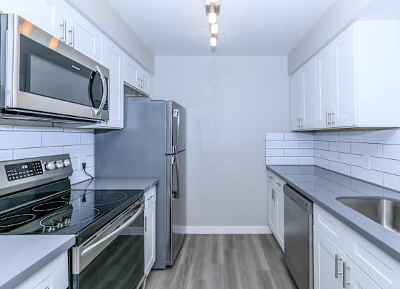 a kitchen with stainless steel appliances and white cabinets at Tides at Mesa, Mesa, AZ, 85204