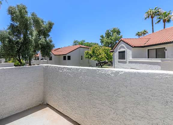 a view from the balcony of a house with a wall and a house at Tides at Mesa, Mesa, 85204