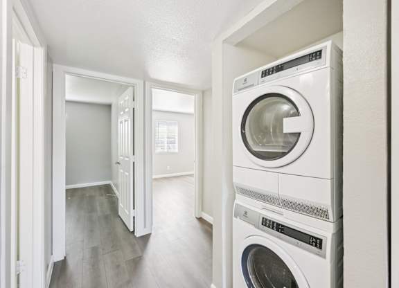A white washing machine and dryer in a laundry room.