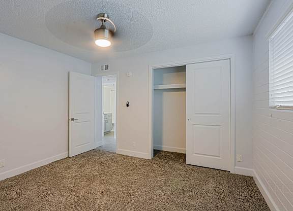 Unfurnished bedroom with closet at Palm Villas, Scottsdale