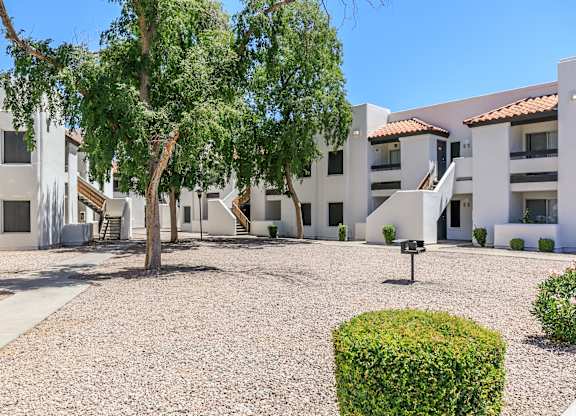 a courtyard with a tree in front of a building at Tides at Mesa, Mesa, 85204