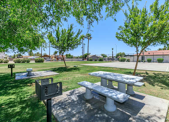 two picnic tables and a grill in a park at Tides at Mesa, Mesa, AZ, 85204