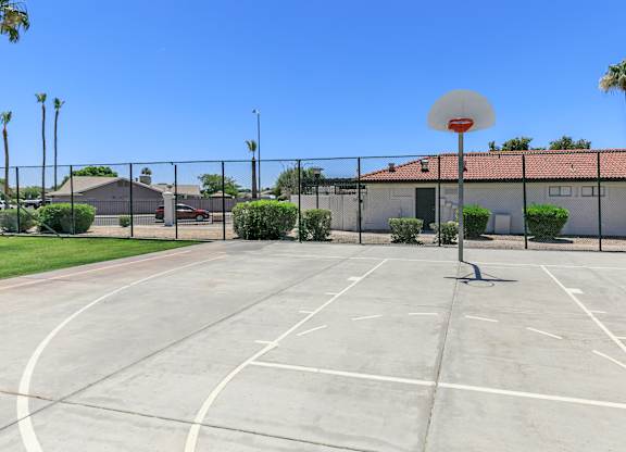 an outdoor basketball court in front of a house with a basketball hoop at Tides at Mesa, Mesa, 85204