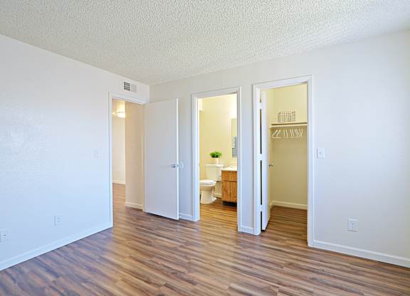 a living room with hardwood floors and white walls