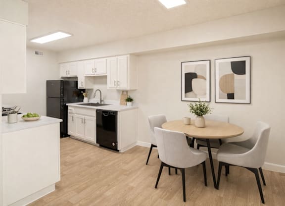 A kitchen with a table and chairs.