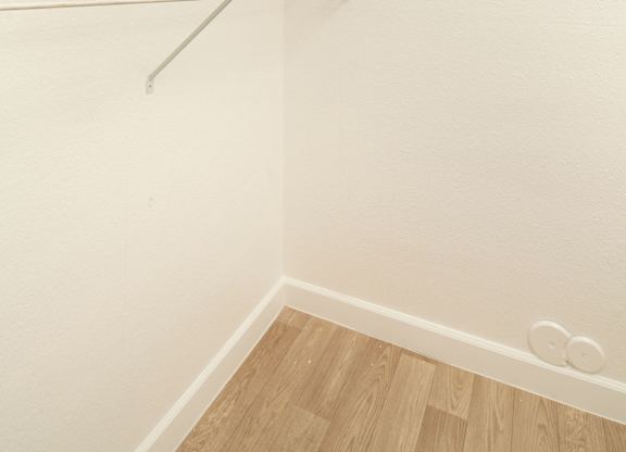 Empty white closet with two shelves.
