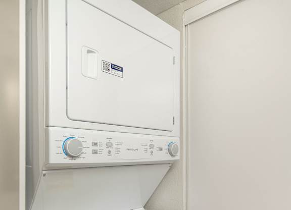 A white dishwasher with a control panel on top.
