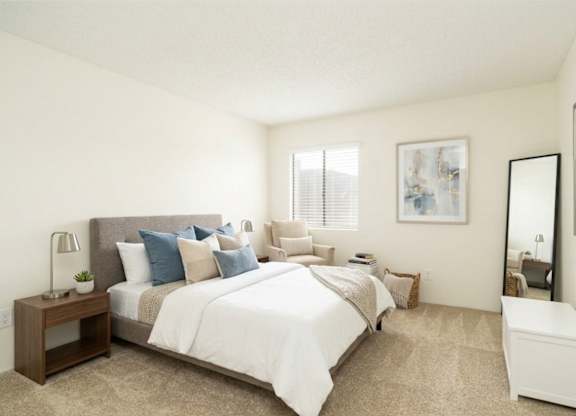 A bedroom with a large bed and a nightstand with a lamp.