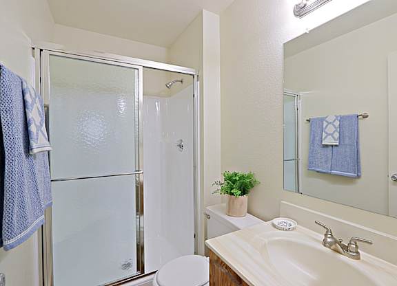 a bathroom with a shower sink and toilet