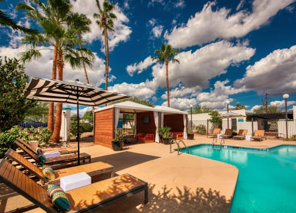 Swimming pool area with a sun lounger at Palm Villas, Scottsdale, AZ