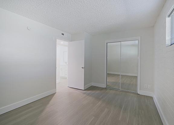 A room with a white door and a white wall.