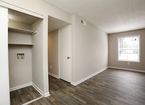 A room with a window and a door.
