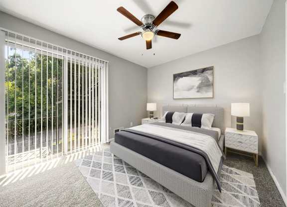 Master bedroom with ceiling fan and light with bed at Georgian Oaks Apartments l & ll* Apartments, Smyrna , Georgia