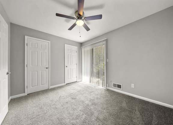 Master bedroom with ceiling fan and light at Georgian Oaks Apartments l & ll* Apartments, Smyrna