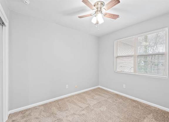 an empty bedroom with a ceiling fan at Georgian Oaks Apartments l & ll* Apartments, Smyrna , Georgia