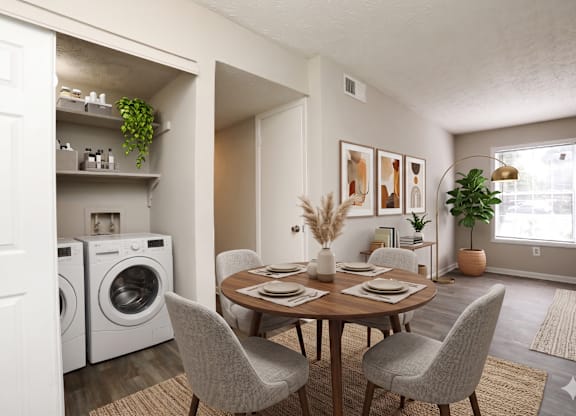 A dining room with a table set for four and a laundry room with a washer and dryer.
