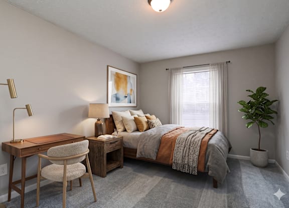 A bedroom with a bed, desk, chair, and a potted plant.