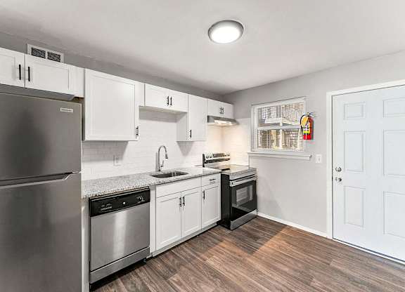 White Cabinetry And Appliances In Kitchen at Gardens at Washington Park, Atlanta