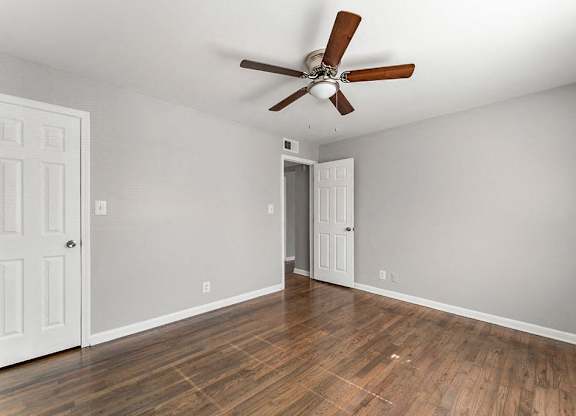 Bedroom with hardwood floors and a ceiling fan at Gardens at Washington Park, Georgia