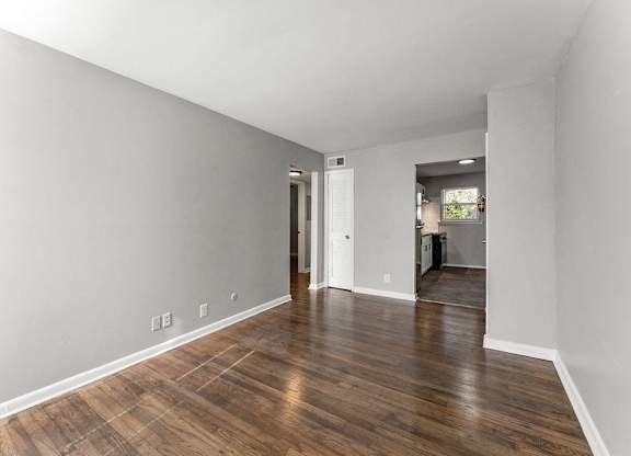 the living room and dining room area of a house with wood floors at Gardens at Washington Park, Atlanta, GA, Georgia , 30314