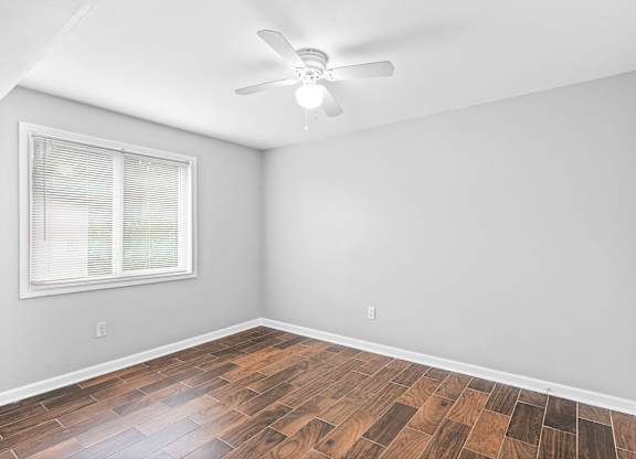 Light and airy bedroom with ceiling fan and a window at Gardens at Washington Park, Atlanta