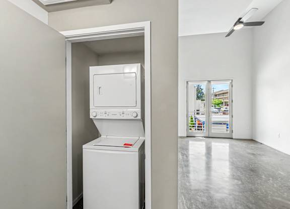 A white washing machine is in a small room.