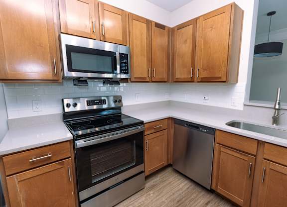 A kitchen with wooden cabinets and stainless steel appliances.