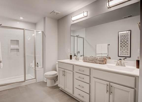 a white bathroom with a shower and a sink