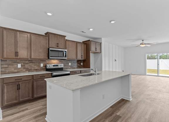A kitchen with brown cabinets and a white island.