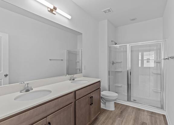 A bathroom with a white sink and a toilet.