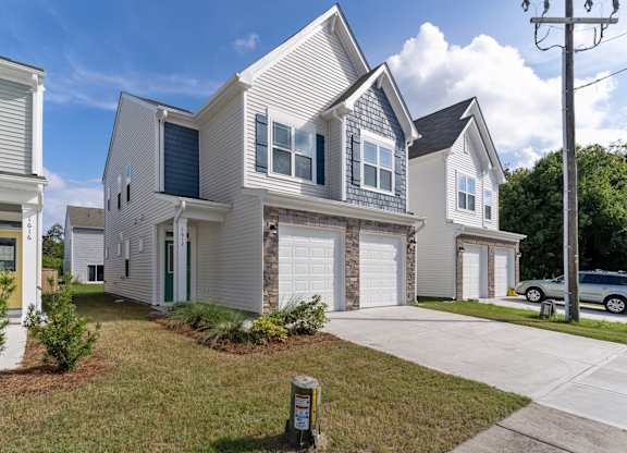 a white house with a white garage door in front of it