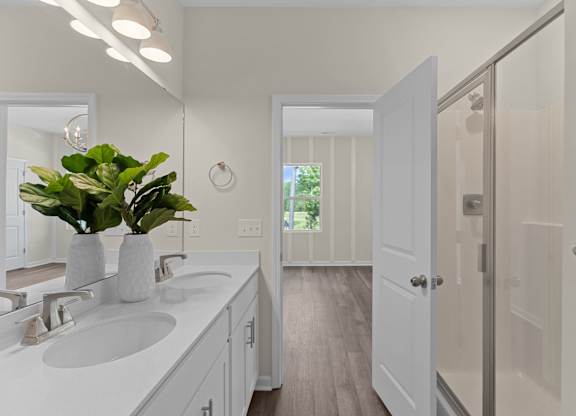 A bathroom with a white sink and a mirror.