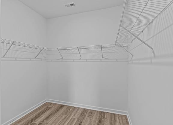 Empty room with white walls and wooden floor.