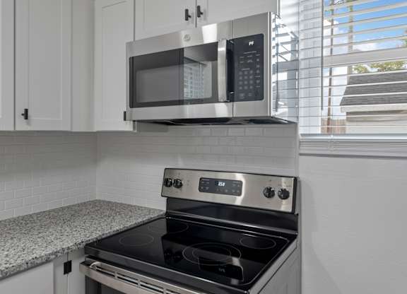 a kitchen with a stove and a microwave