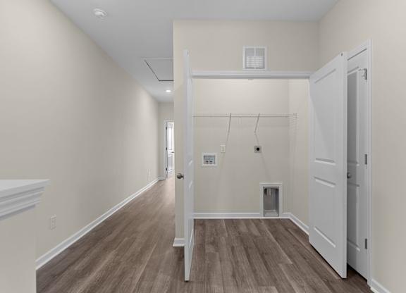 A room with a white door and a white cabinet.