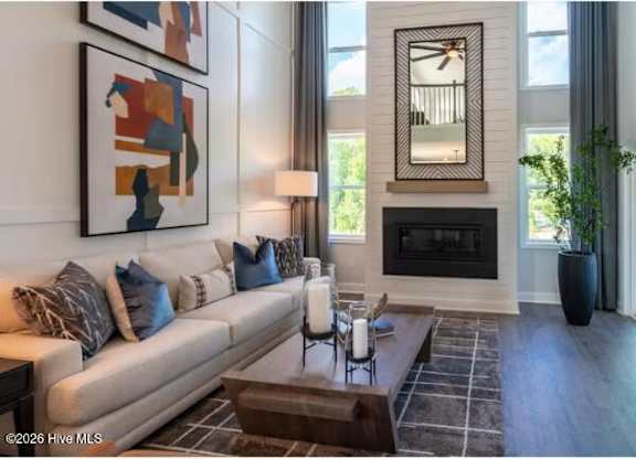 A living room with a fireplace and a painting on the wall.