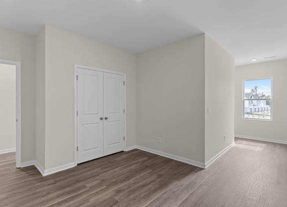 A room with a white door and a window.