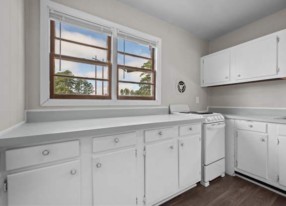 A laundry room with a window and a washer and dryer.