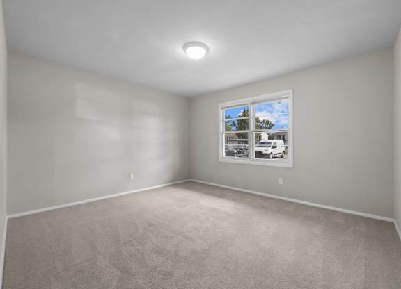 A room with a car poster on the wall.