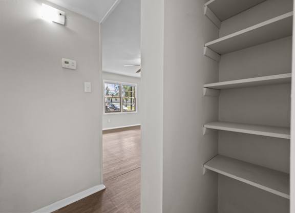 Empty shelves in a room with a window.